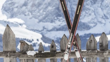 paio di sci di fronta ad un recinto tradizionale di legno